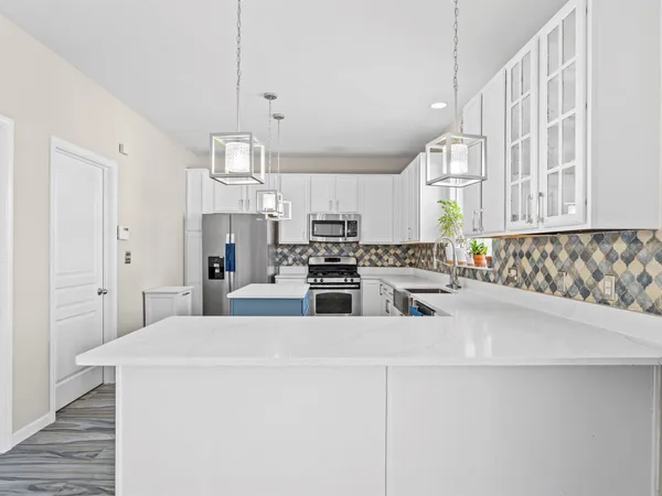 a kitchen with stainless steel appliances a refrigerator sink and cabinets