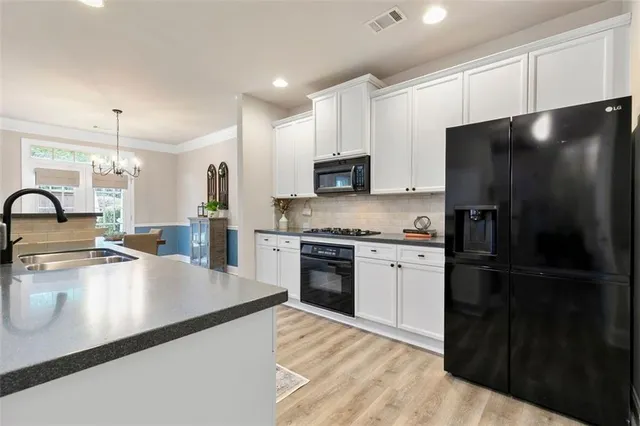 a kitchen with a refrigerator and a sink