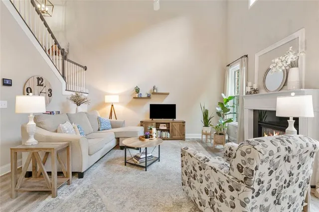a living room with furniture a fireplace and a flat screen tv