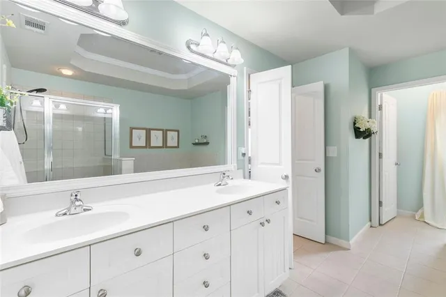 a bathroom with a sink double vanity and a mirror
