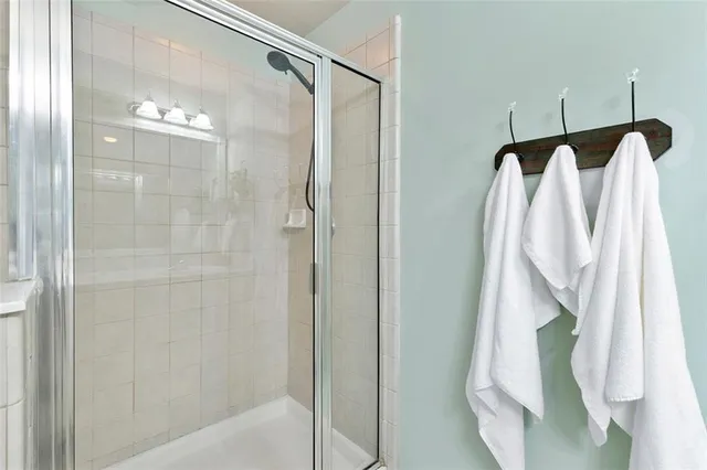 a bathroom that has a glass shower door