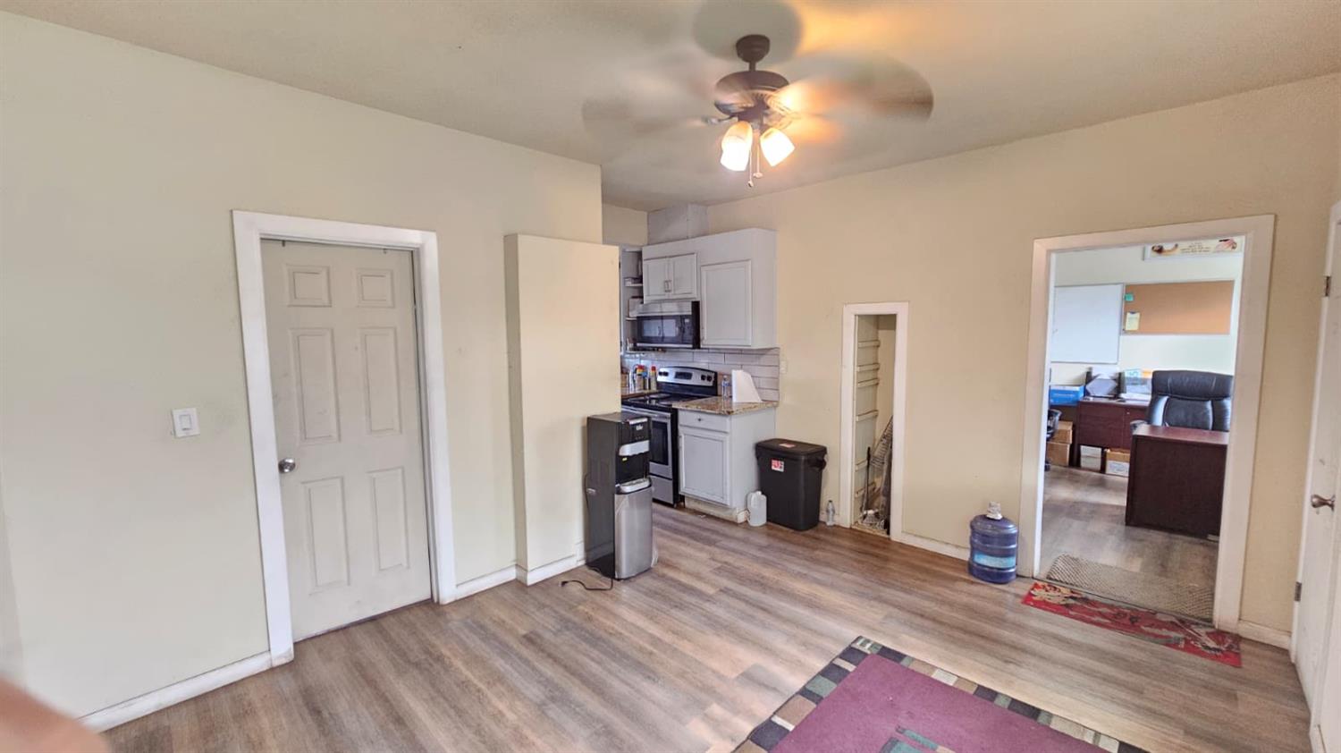 11881 Griffith Road Turlock, CA 95380 - Photo 17 of 42 a view of a livingroom with a furniture hardwood floor and a ceiling fan