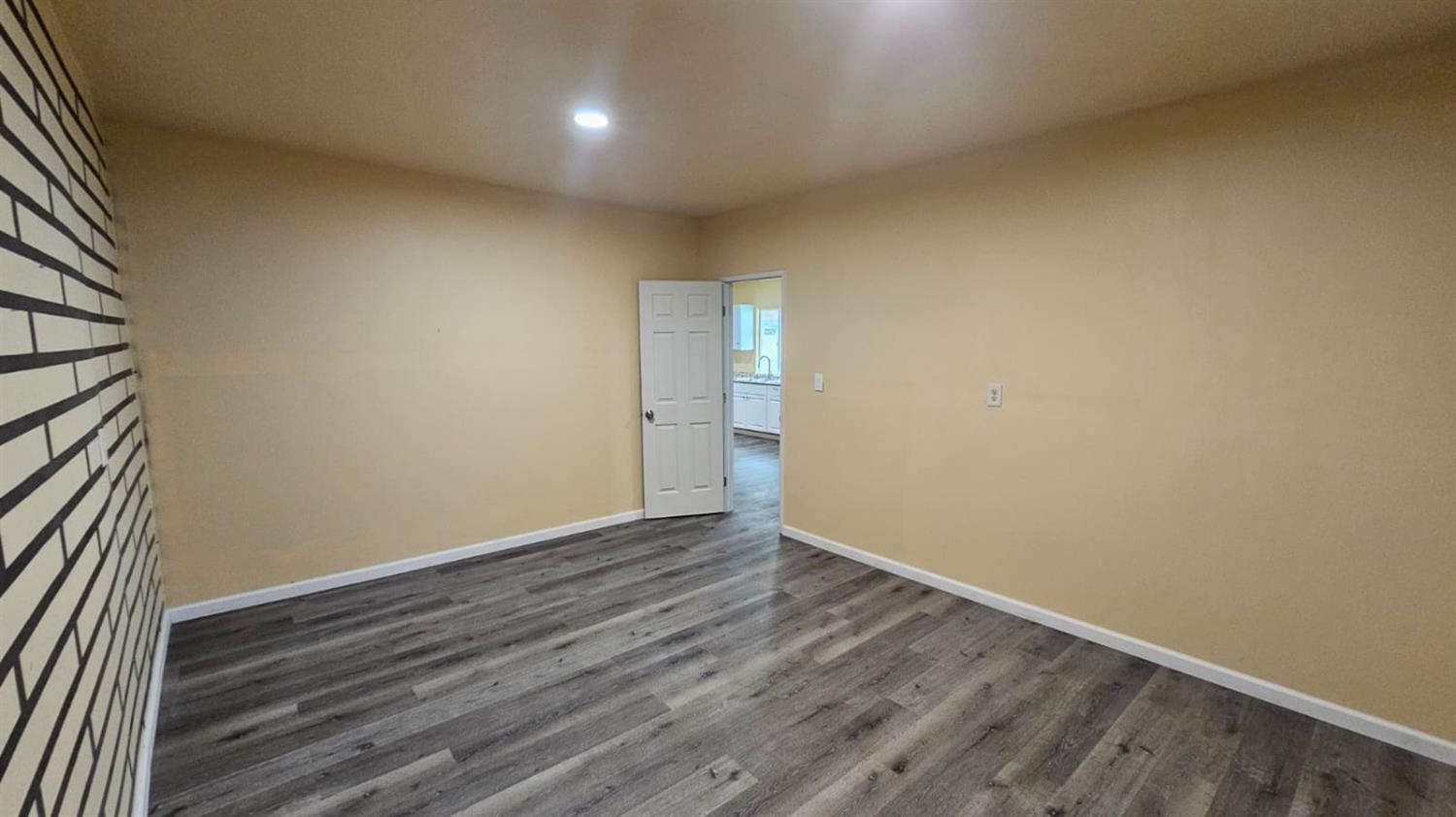 11881 Griffith Road Turlock, CA 95380 - Photo 23 of 42 an empty room with wooden floor and windows