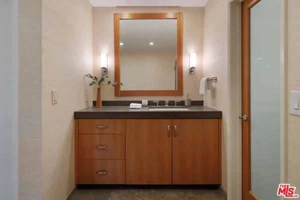 a bathroom with a glass shower door