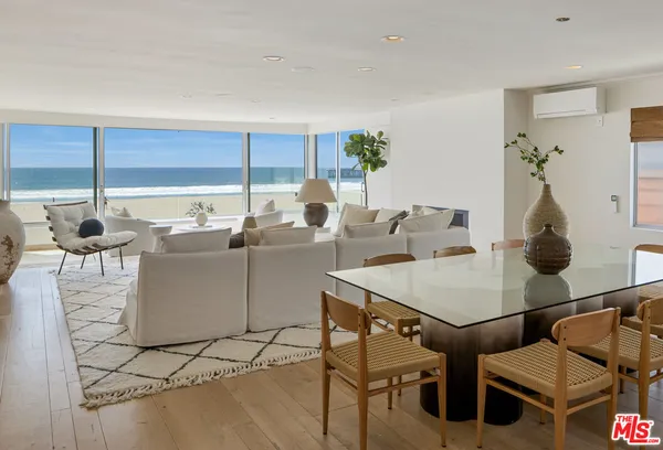 a living room with furniture a rug and white walls