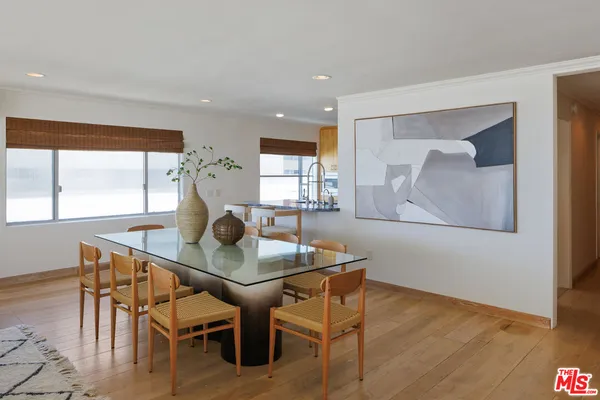 a dining room with furniture and wooden floor
