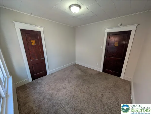 a view of an empty room and a window