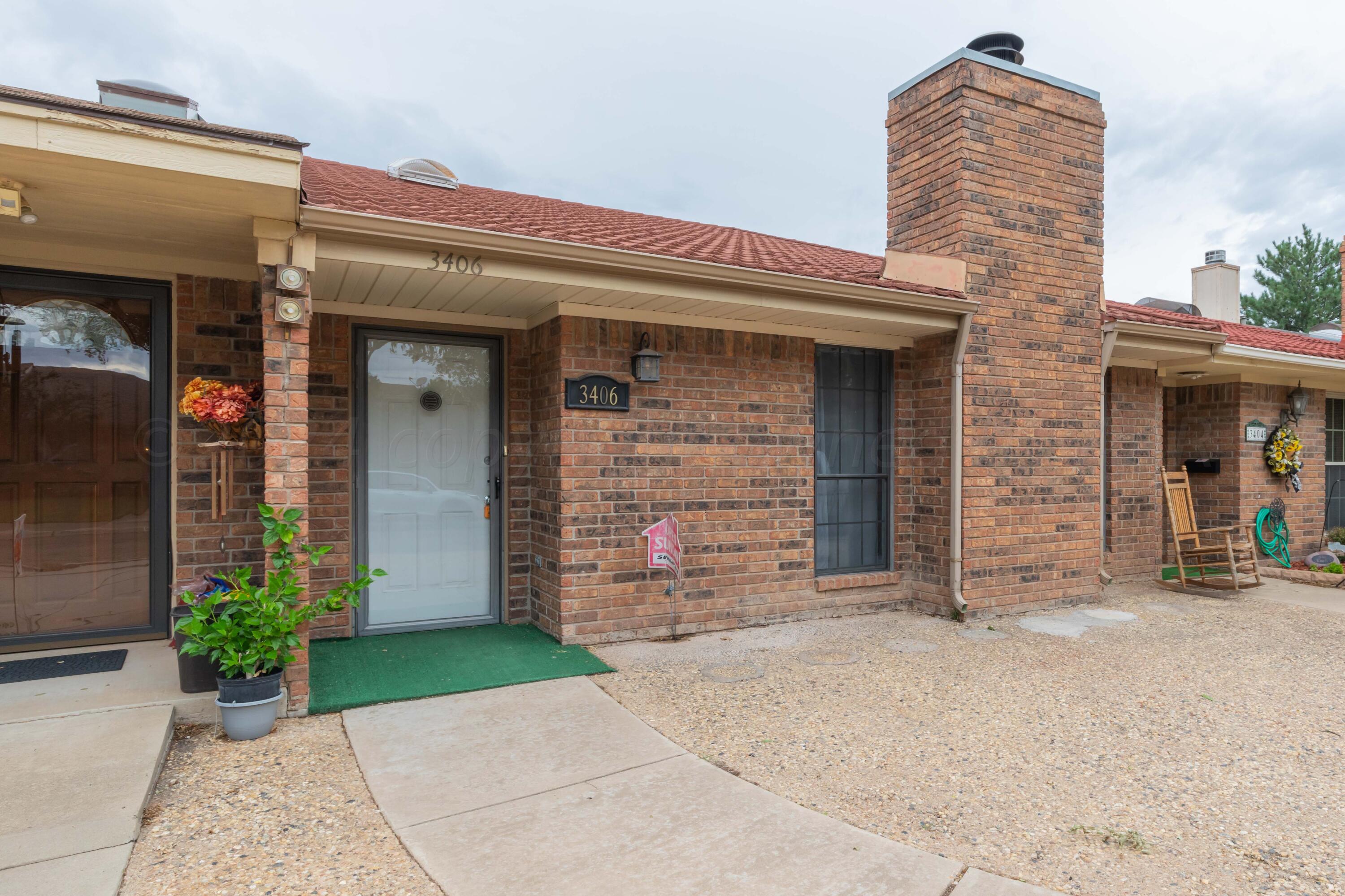 3406 Gladstone Lane Amarillo, TX 79121 - Photo 1 of 35 front view of a brick house with a small yard