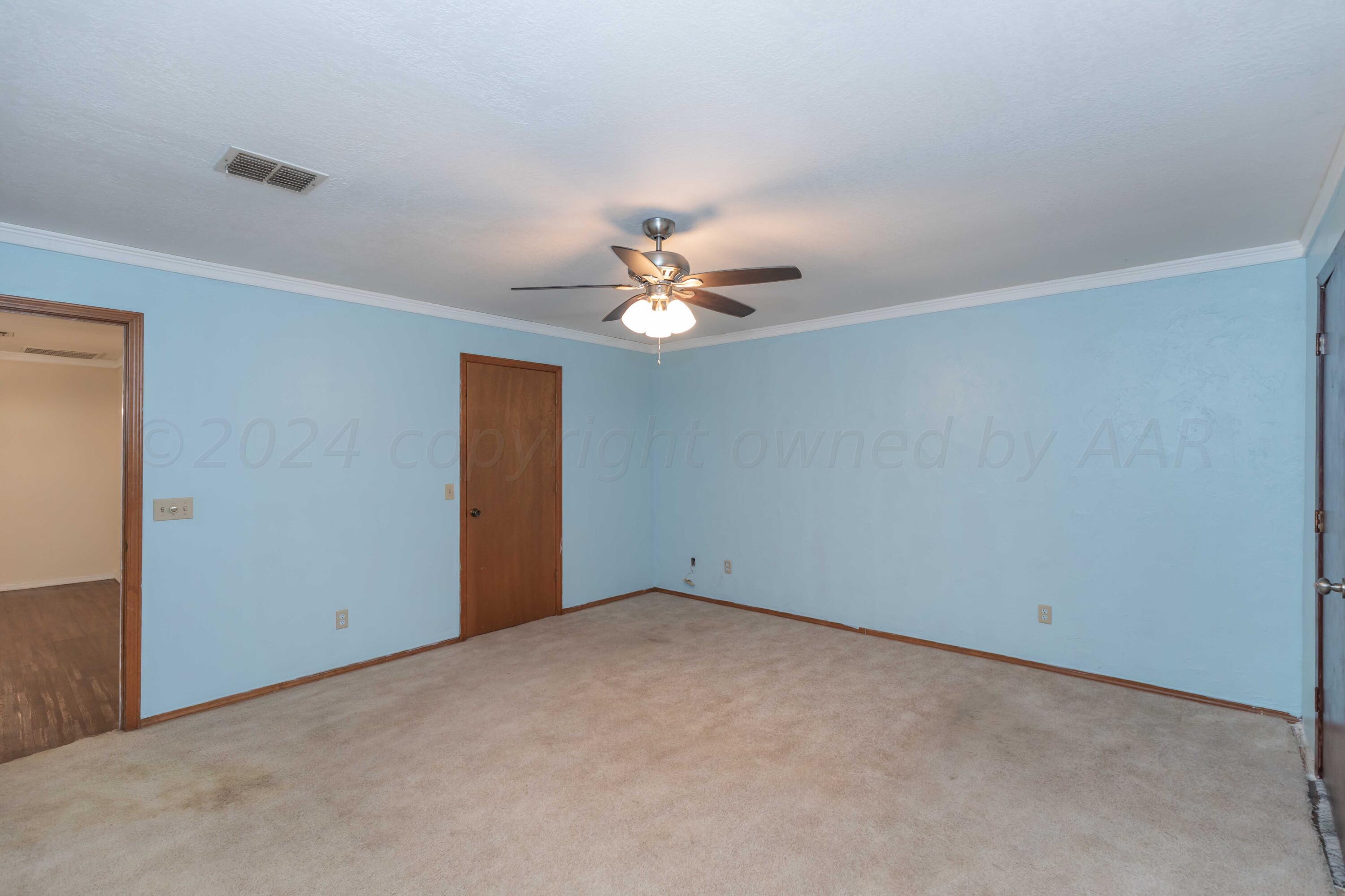 3406 Gladstone Lane Amarillo, TX 79121 - Photo 20 of 35 a view of a room with a ceiling fan and a window