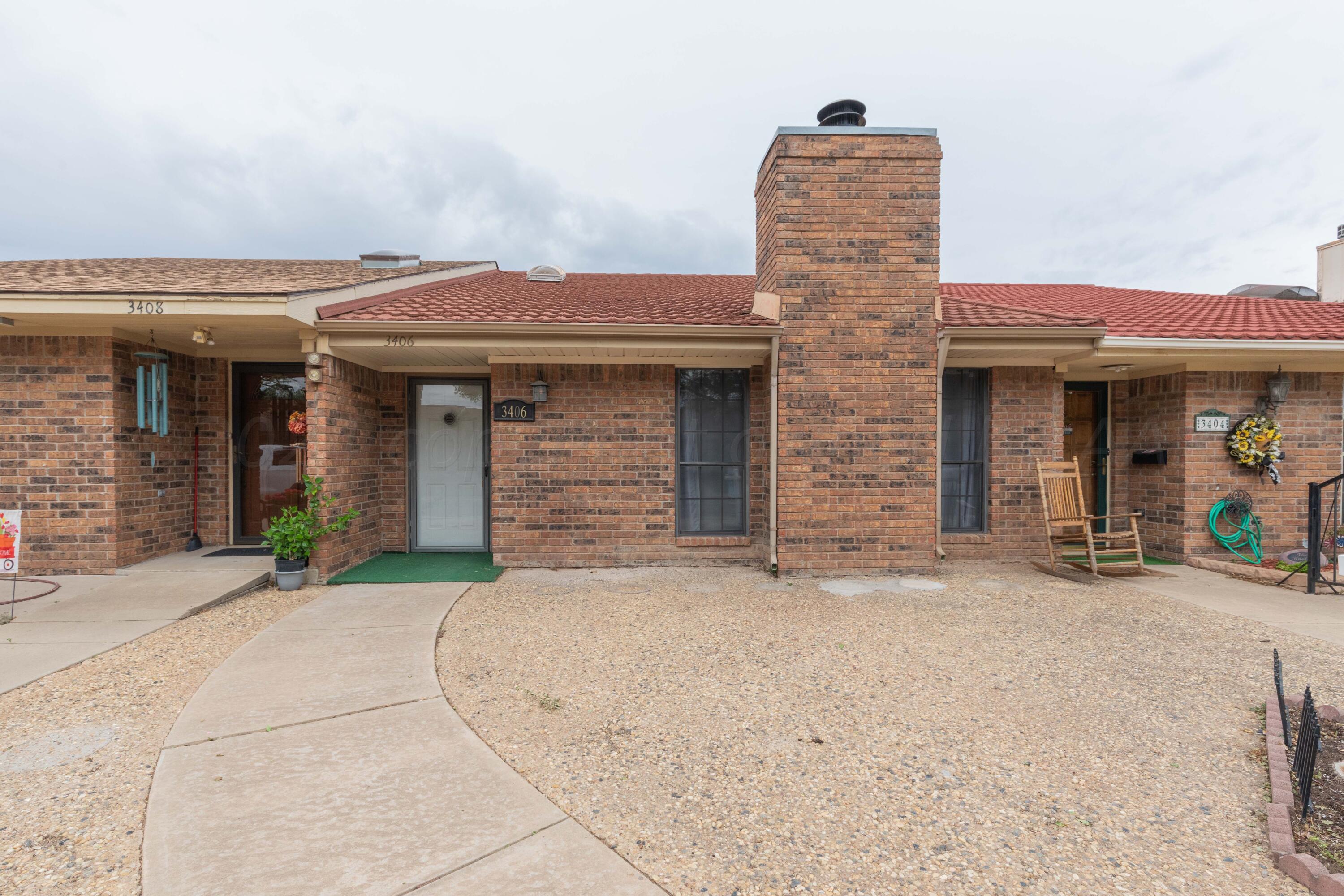3406 Gladstone Lane Amarillo, TX 79121 - Photo 2 of 35 front view of a brick house with a small yard