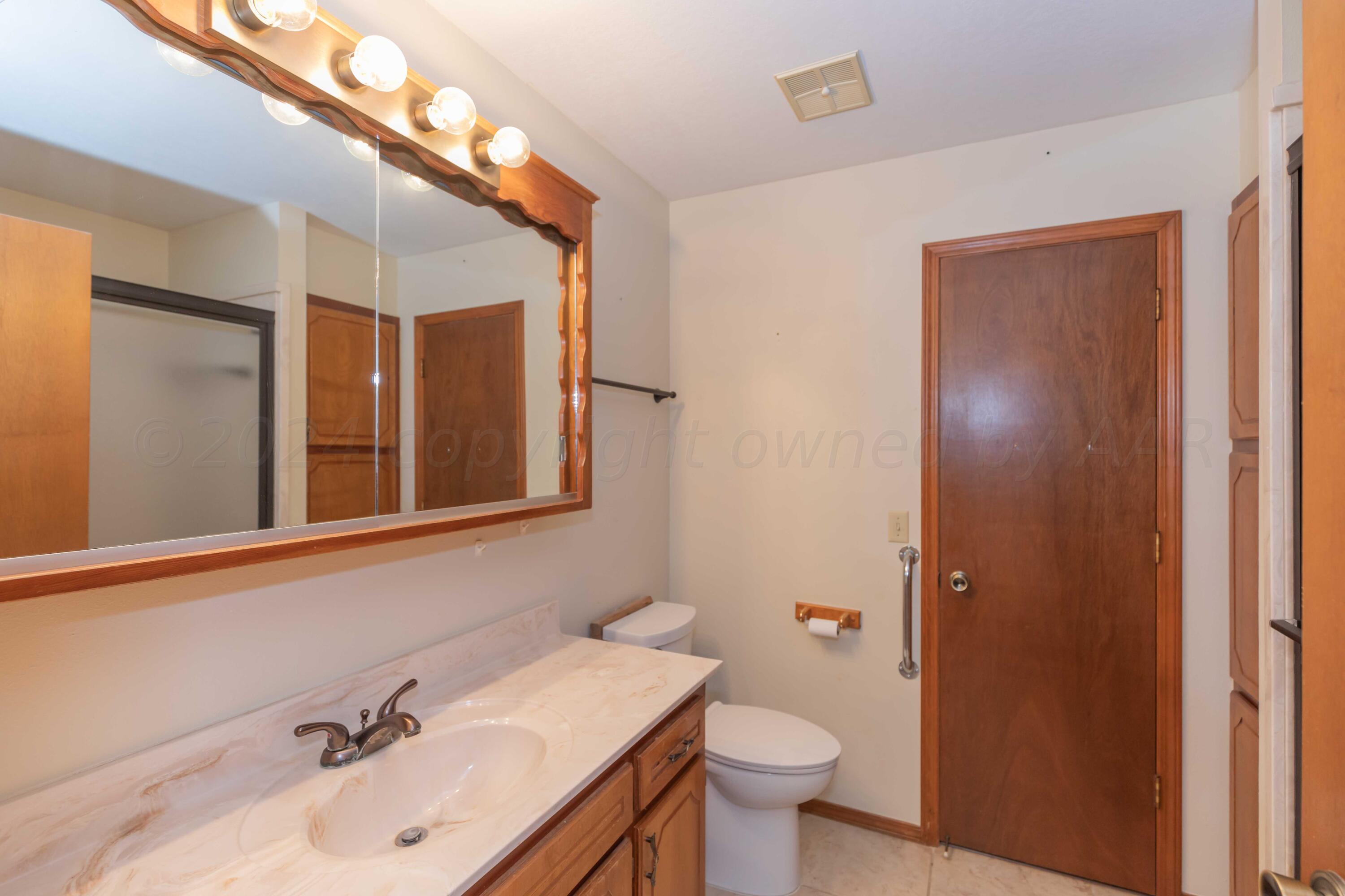 3406 Gladstone Lane Amarillo, TX 79121 - Photo 30 of 35 a bathroom with a sink and a mirror