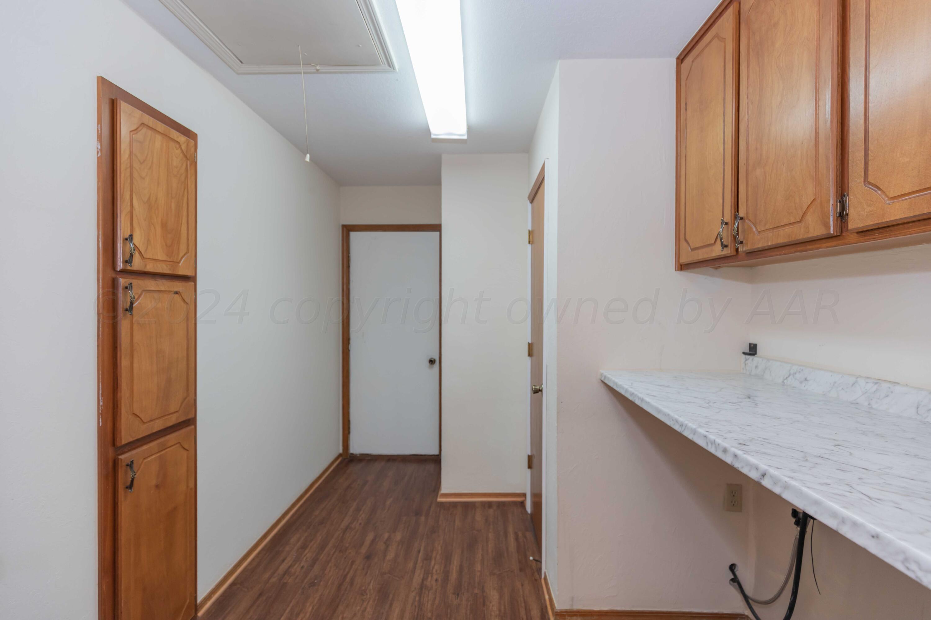 3406 Gladstone Lane Amarillo, TX 79121 - Photo 33 of 35 a kitchen with a refrigerator and cabinets