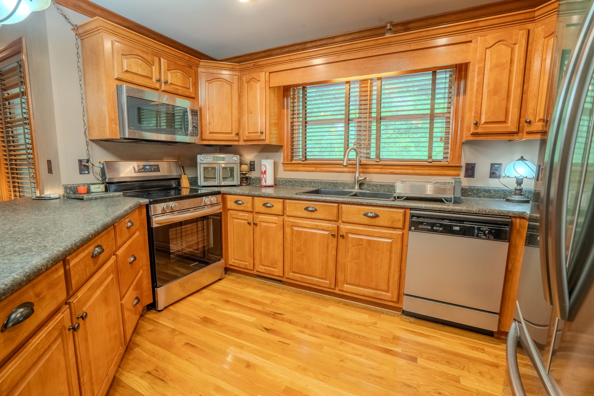410 Britton Hollow Road Pulaski, TN 38478 - Photo 12 of 74 a kitchen with stainless steel appliances granite countertop a stove a sink and a microwave
