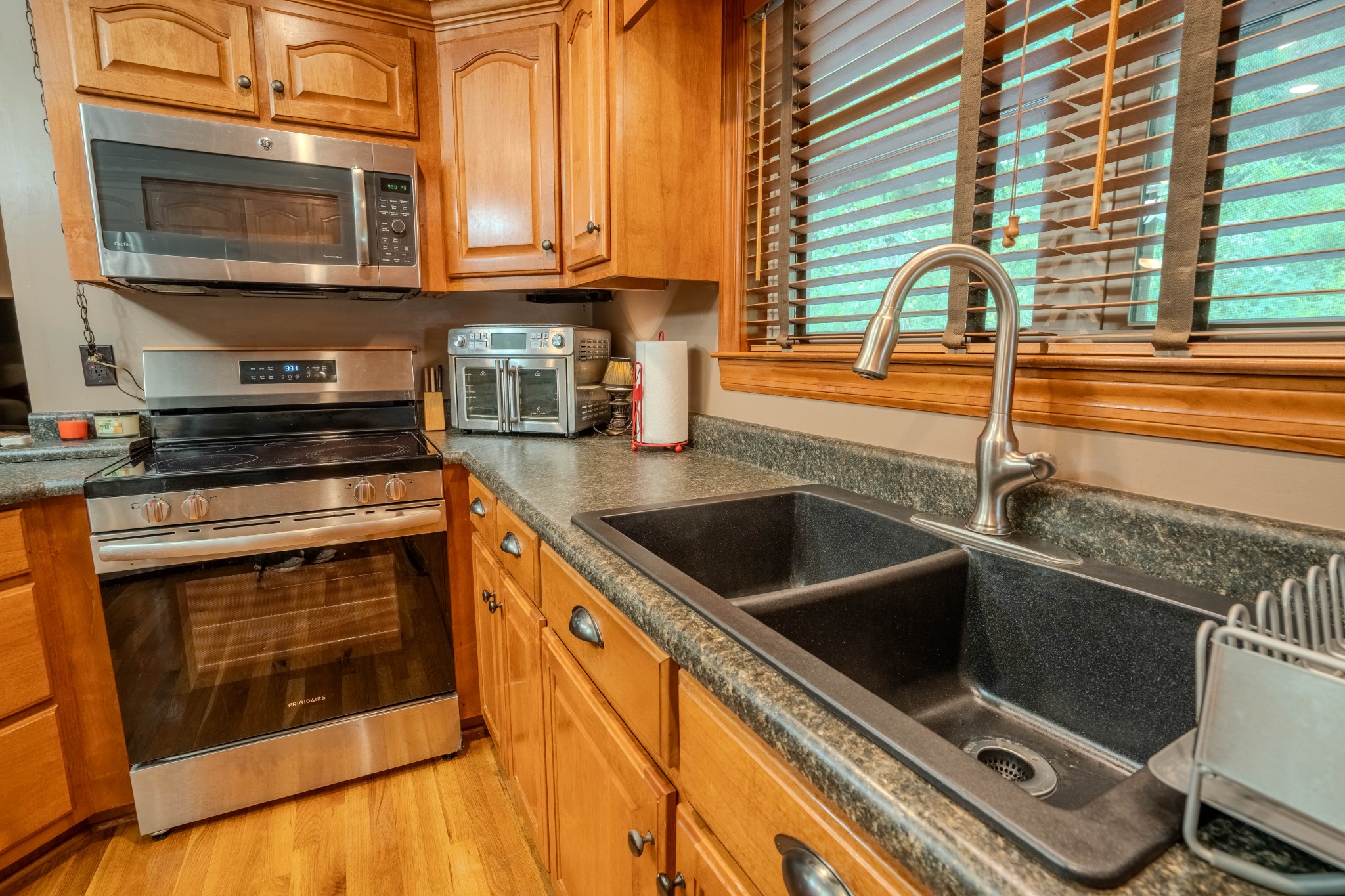 410 Britton Hollow Road Pulaski, TN 38478 - Photo 13 of 74 a kitchen with stainless steel appliances granite countertop a stove a sink and a microwave
