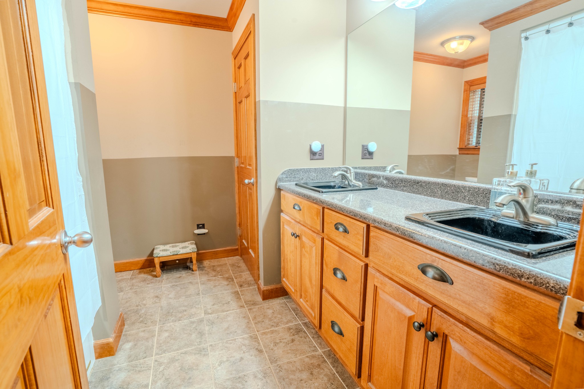 410 Britton Hollow Road Pulaski, TN 38478 - Photo 29 of 74 a spacious bathroom with a granite countertop sink and a large mirror
