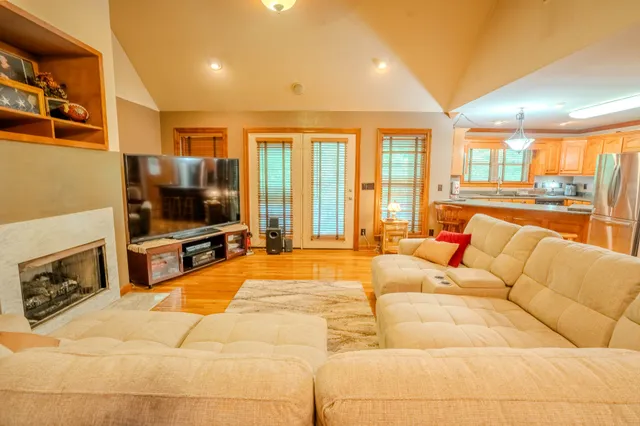 a living room with furniture fireplace and flat screen tv
