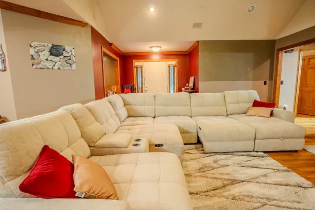 a living room with furniture and large windows