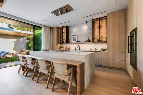a kitchen with kitchen island granite countertop a sink and cabinets