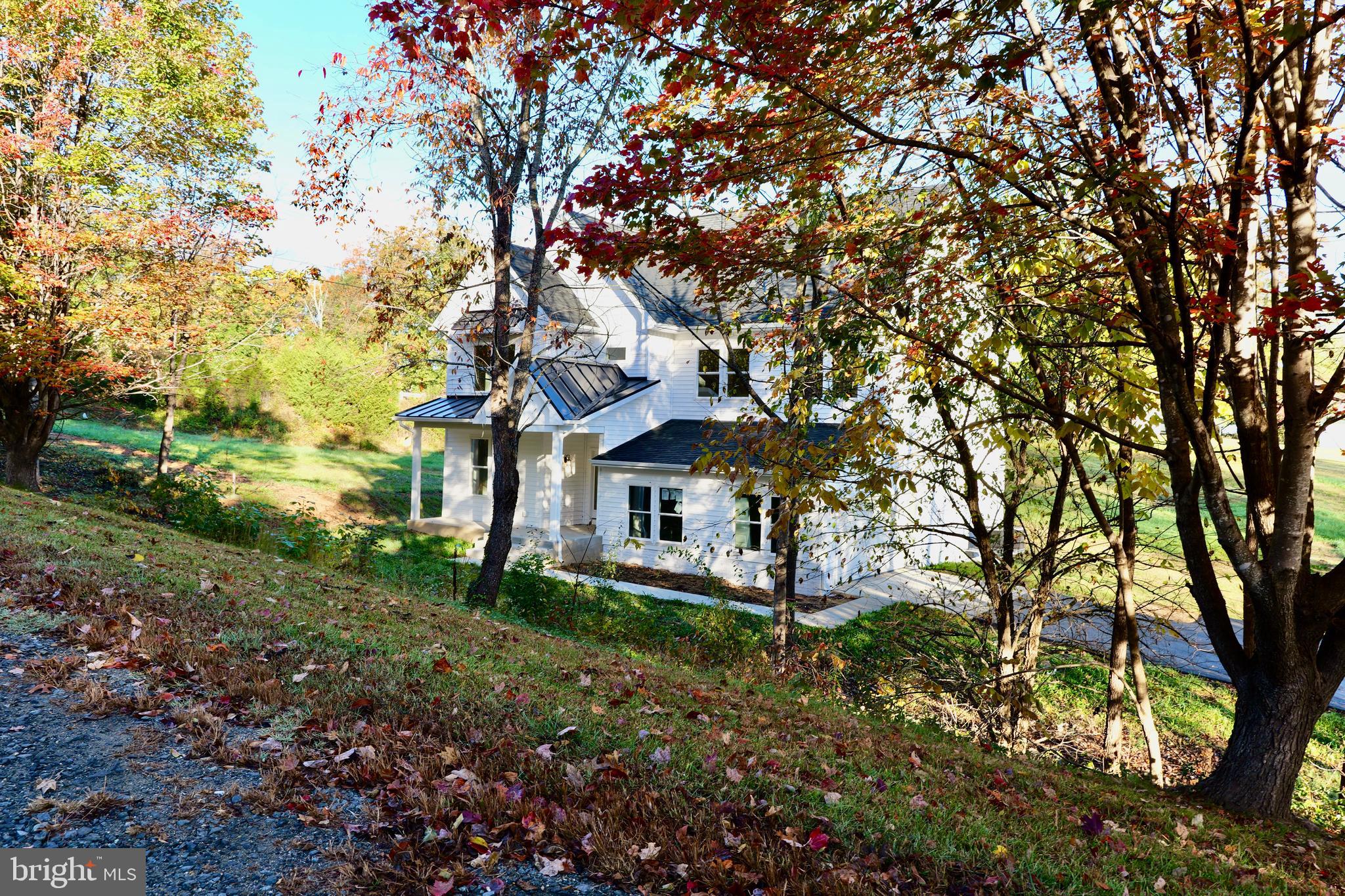 8028 Pinnacle Ridge Drive Manassas, VA 20112 - Photo 11 of 74 a front view of a house with garden