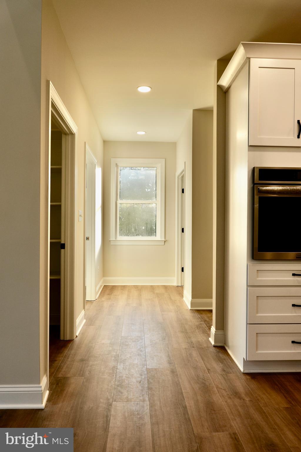 8028 Pinnacle Ridge Drive Manassas, VA 20112 - Photo 16 of 74 a view of an empty room with a window and wooden floor