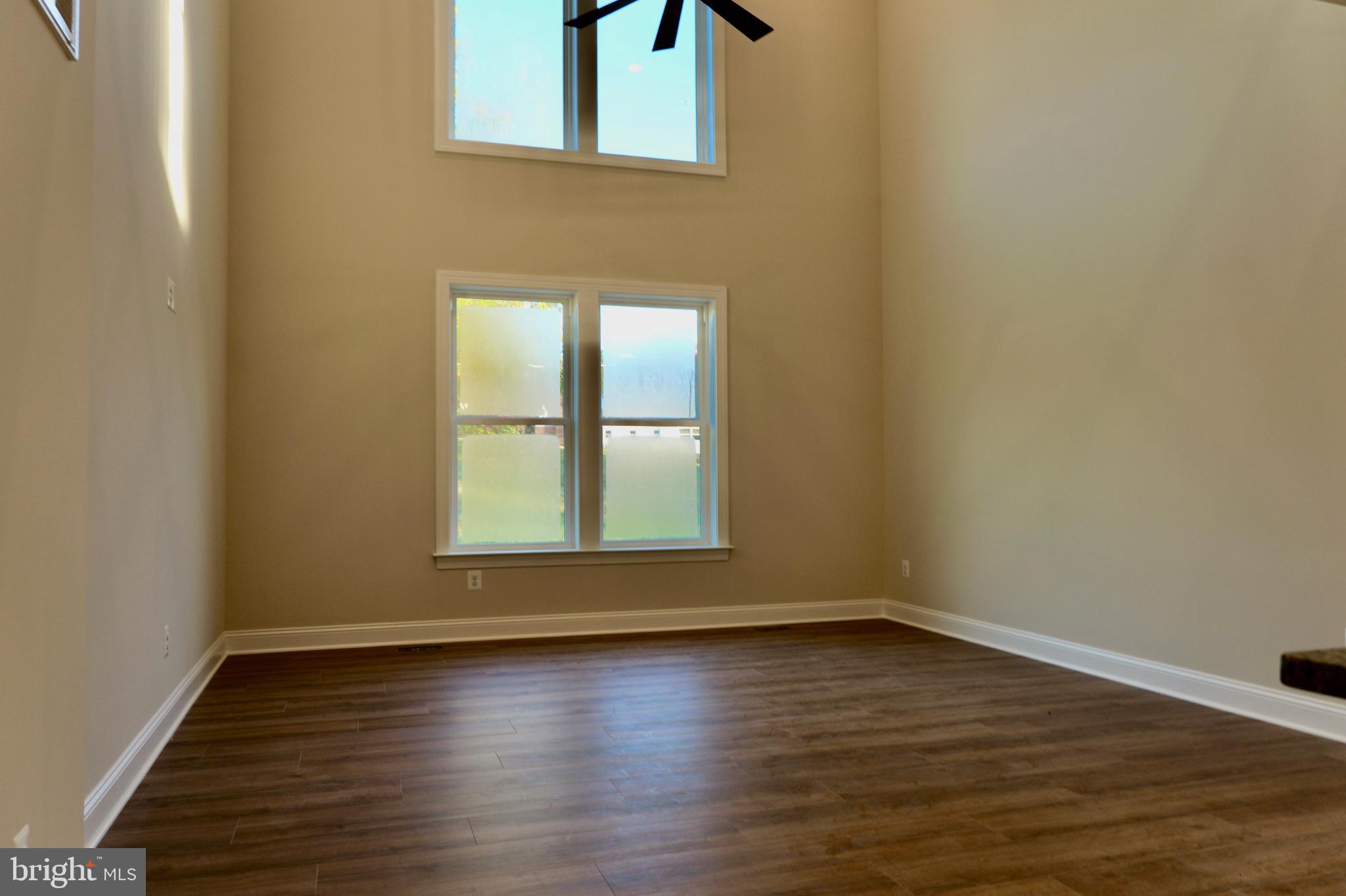 8028 Pinnacle Ridge Drive Manassas, VA 20112 - Photo 19 of 74 a view of an empty room with wooden floor and a window