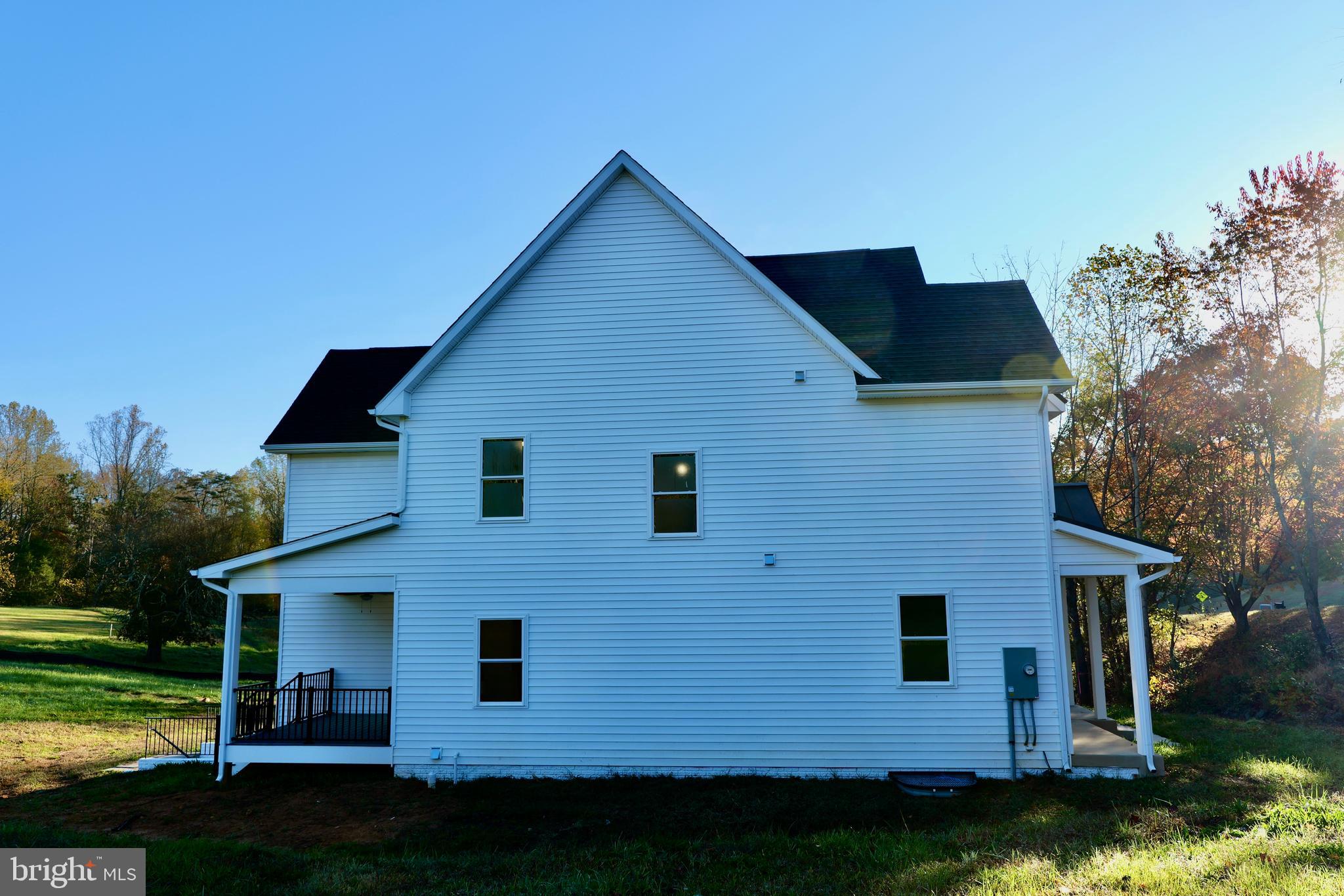 8028 Pinnacle Ridge Drive Manassas, VA 20112 - Photo 3 of 74 a front view of a house with garden