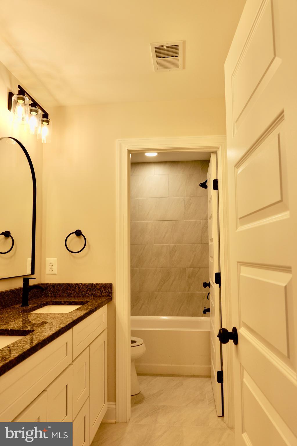 8028 Pinnacle Ridge Drive Manassas, VA 20112 - Photo 46 of 74 a bathroom with a granite countertop sink mirror and bathtub