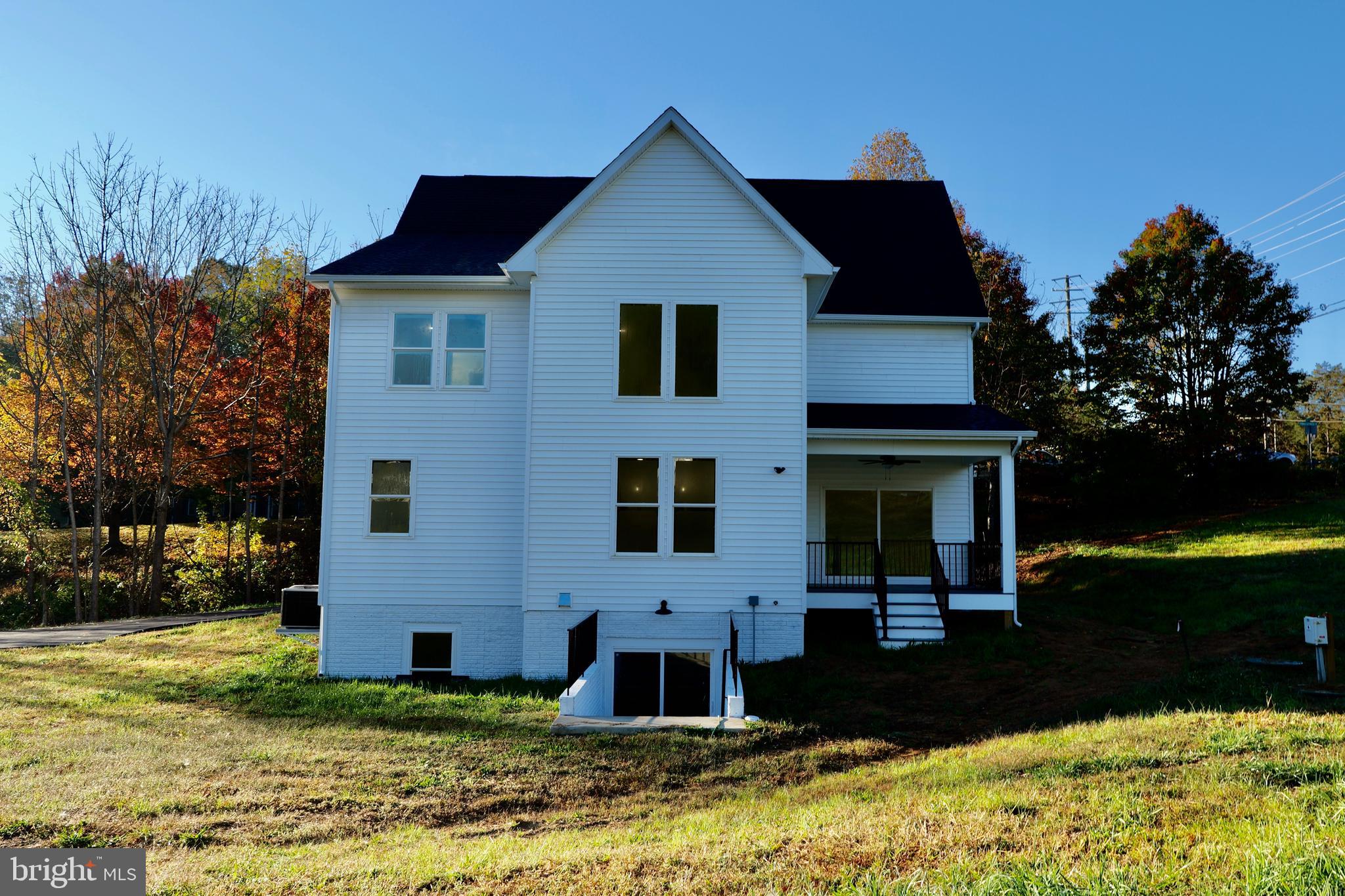 8028 Pinnacle Ridge Drive Manassas, VA 20112 - Photo 5 of 74 a front view of a house with garden