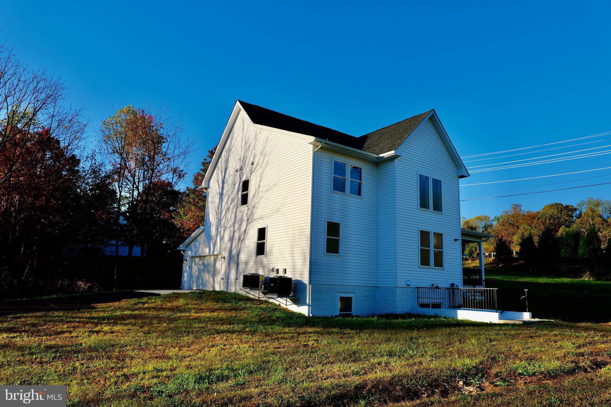 8028 Pinnacle Ridge Drive Manassas, VA 20112 - Photo 6 of 74 a view of a house with backyard and tree