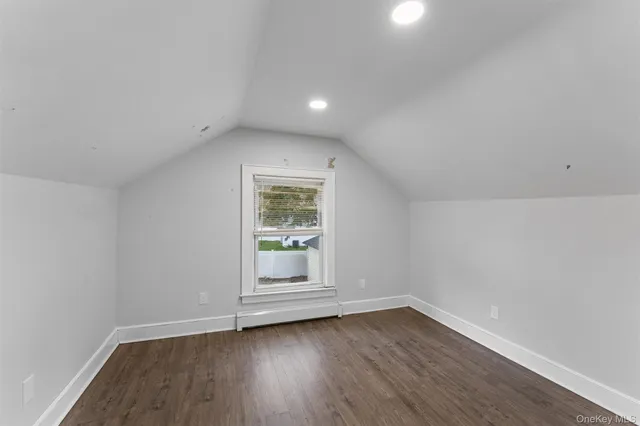 a view of wooden floor and chandelier in a room