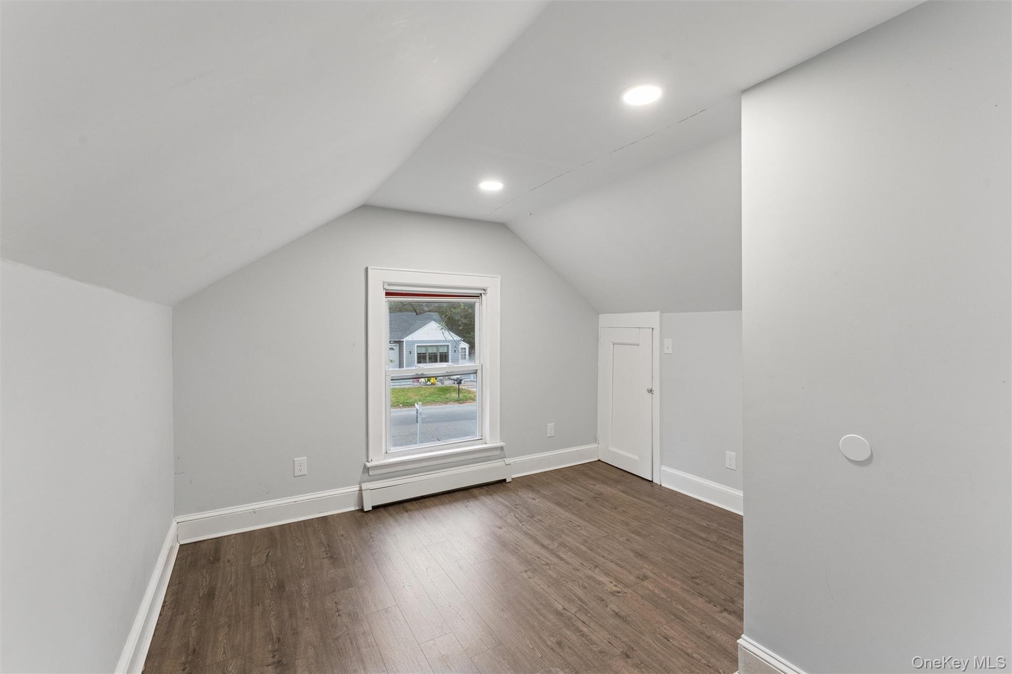 242 Bayview Drive Mastic Beach, NY 11951 - Photo 13 of 18 an empty room with wooden floor and window