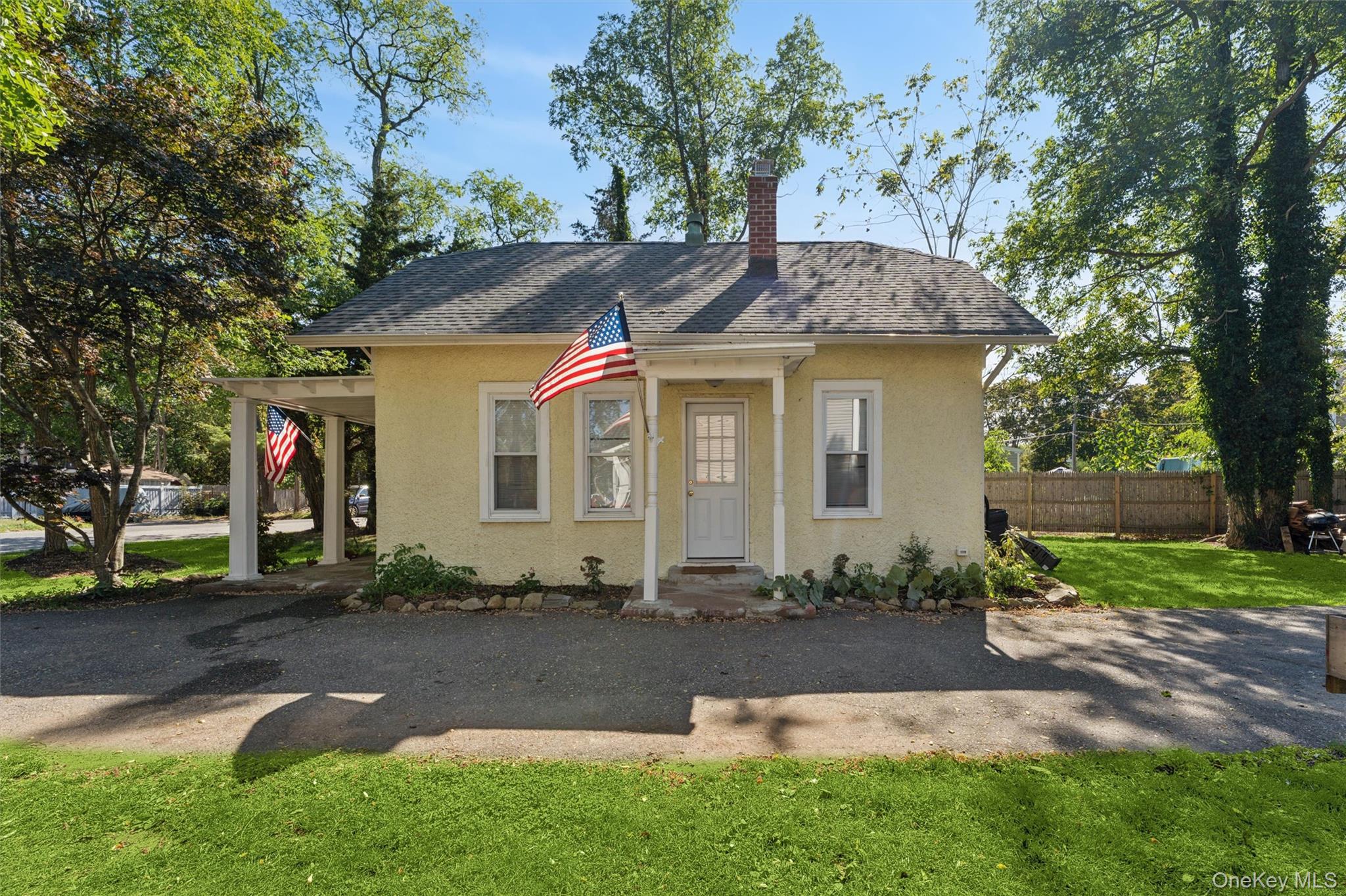 242 Bayview Drive Mastic Beach, NY 11951 - Photo 18 of 18 a front view of a house with garden