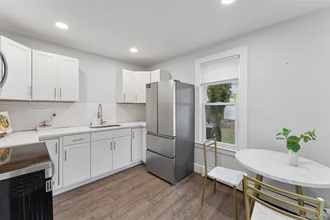 a kitchen with stainless steel appliances granite countertop a refrigerator sink and stove