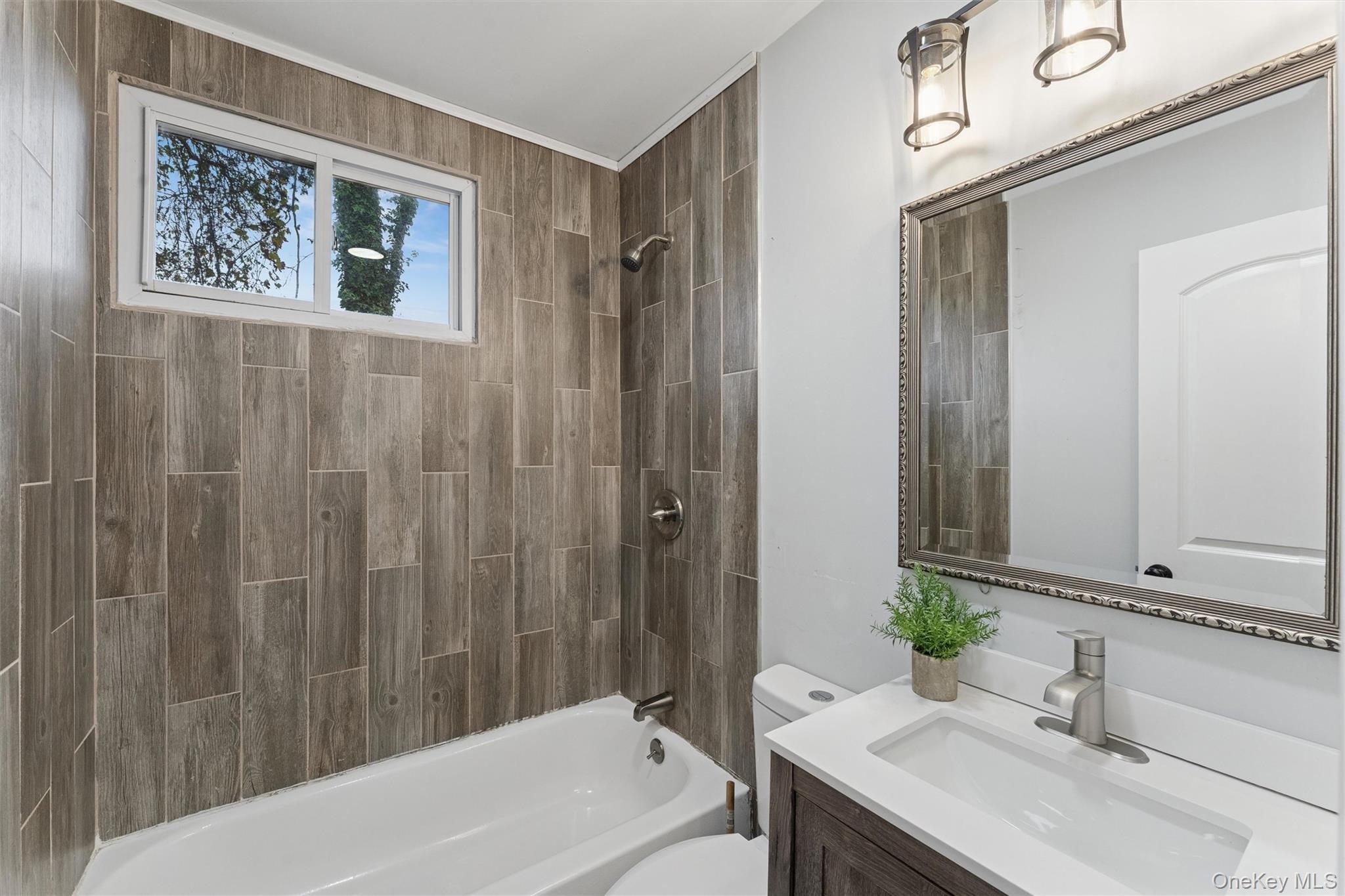 242 Bayview Drive Mastic Beach, NY 11951 - Photo 7 of 18 a bathroom with a tub a sink and mirror