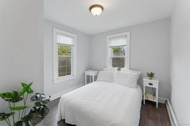 a bedroom with a bed table and a window