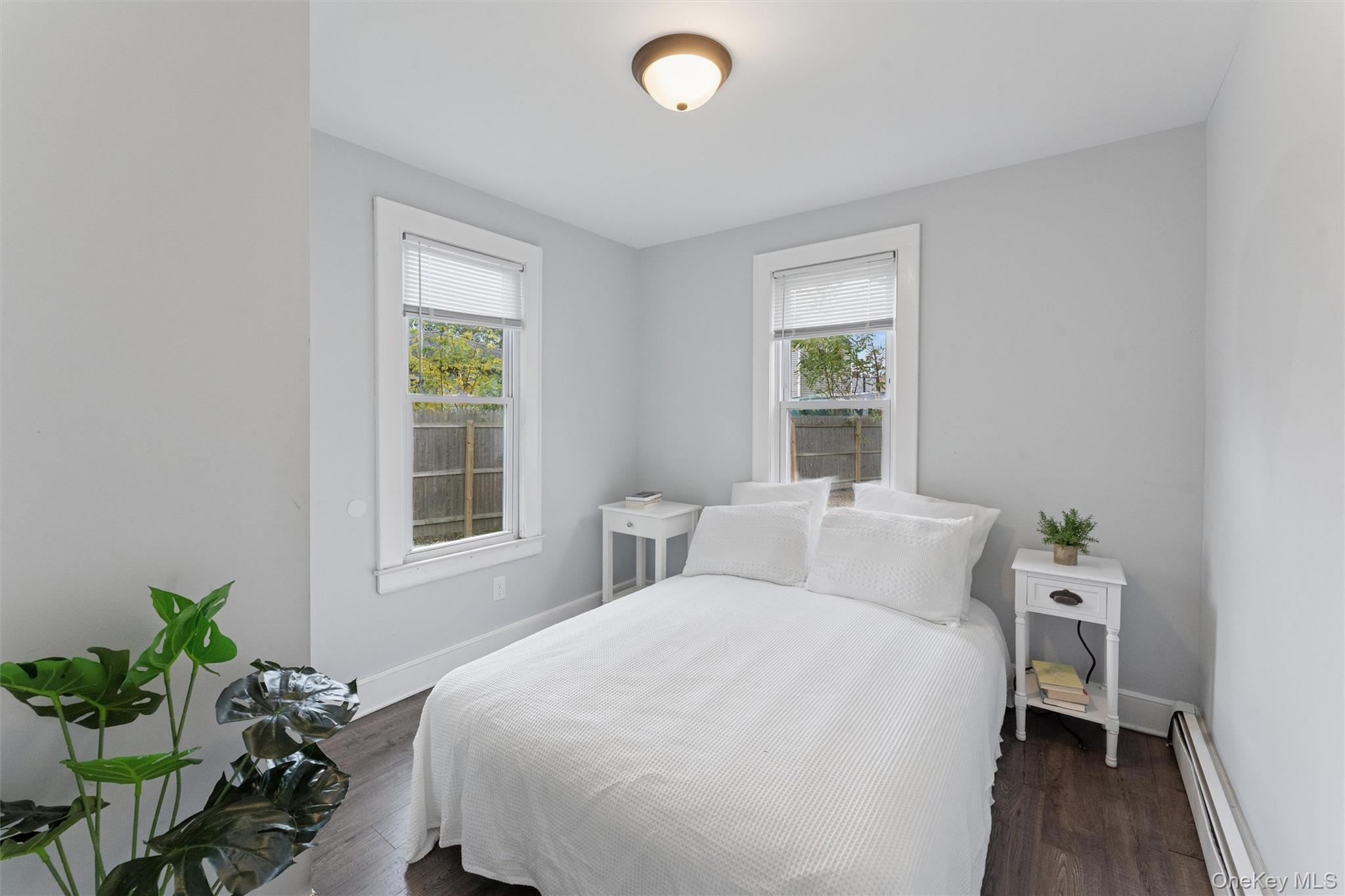 242 Bayview Drive Mastic Beach, NY 11951 - Photo 8 of 18 a bedroom with a bed table and a window