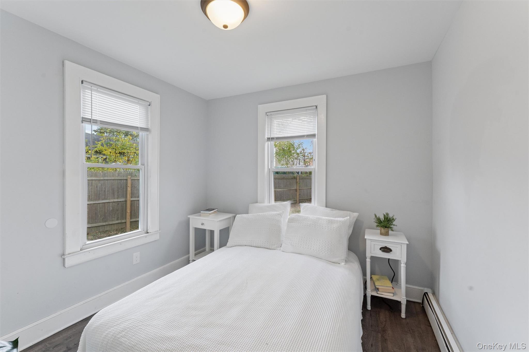 242 Bayview Drive Mastic Beach, NY 11951 - Photo 9 of 18 a bedroom with a bed and a window