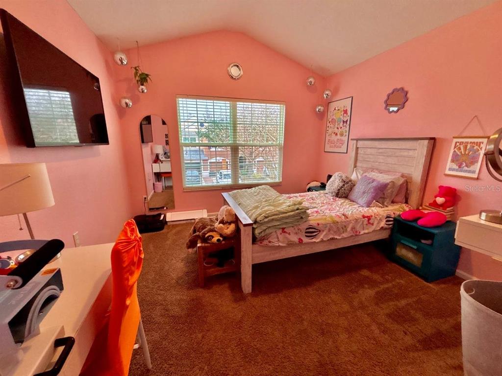 26618 Castleview Way Wesley Chapel, FL 33544 - Photo 18 of 29 a bedroom with furniture and a flat screen tv