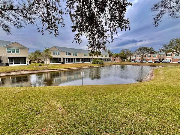 a swimming pool with outdoor seating and yard