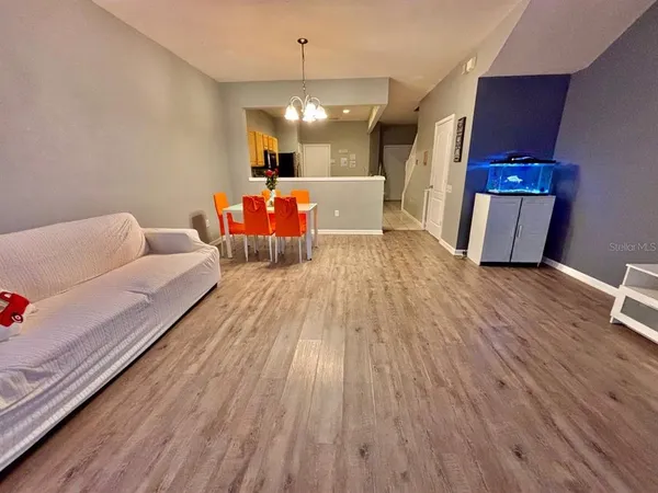 a view of a livingroom with furniture wooden floor and chandelier