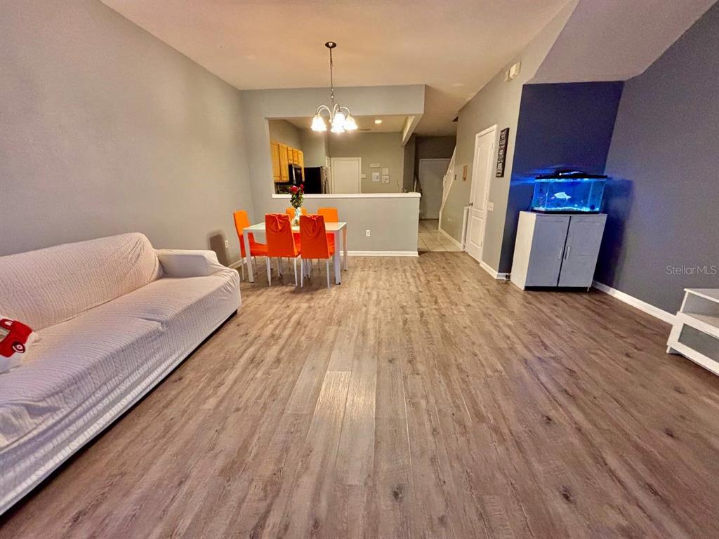 26618 Castleview Way Wesley Chapel, FL 33544 - Photo 3 of 29 a view of a livingroom with furniture wooden floor and chandelier