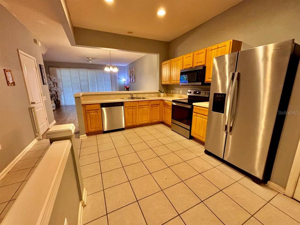 26618 Castleview Way Wesley Chapel, FL 33544 - Photo 5 of 29 a kitchen with stainless steel appliances a refrigerator sink and microwave