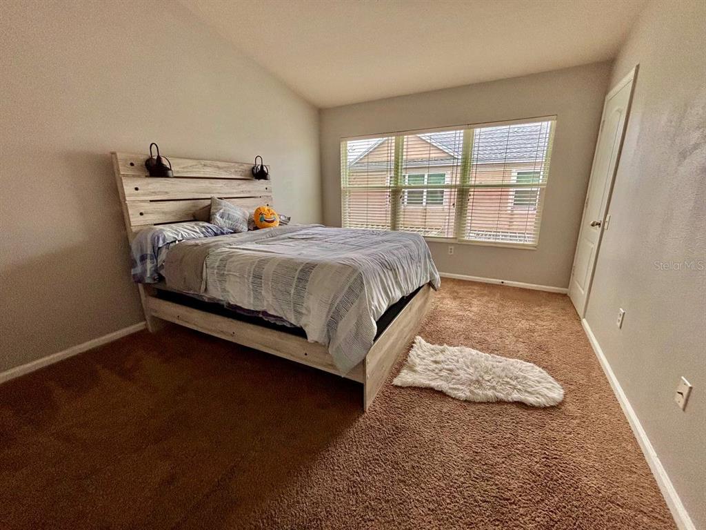 26618 Castleview Way Wesley Chapel, FL 33544 - Photo 9 of 29 a bed sitting in a bedroom next to a window