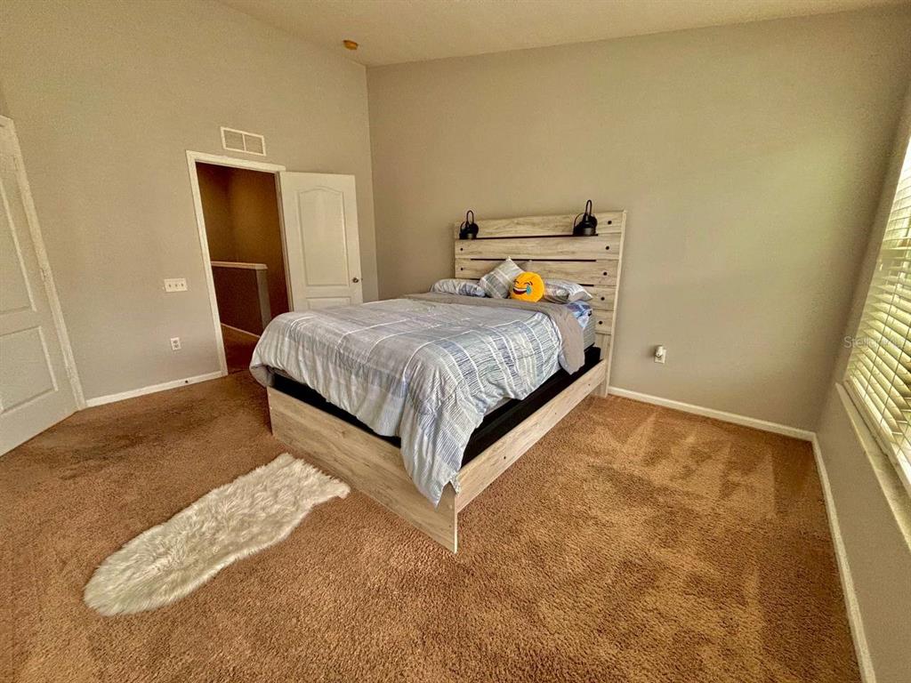 26618 Castleview Way Wesley Chapel, FL 33544 - Photo 10 of 29 a bed sitting in a bedroom next to a window