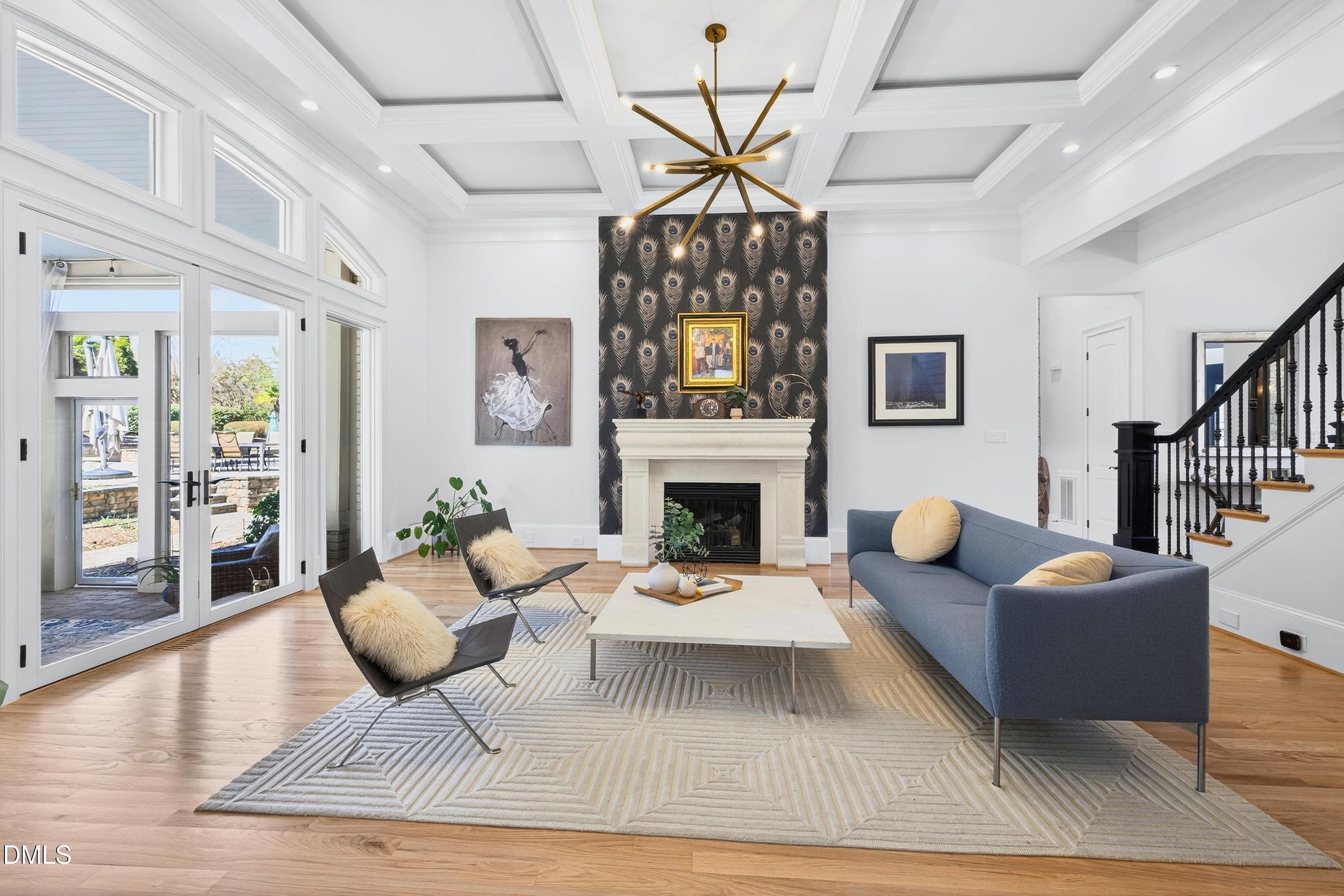 6701 Foxfire Place Raleigh, NC 27615 - Photo 5 of 67 a living room with furniture a fireplace and a chandelier