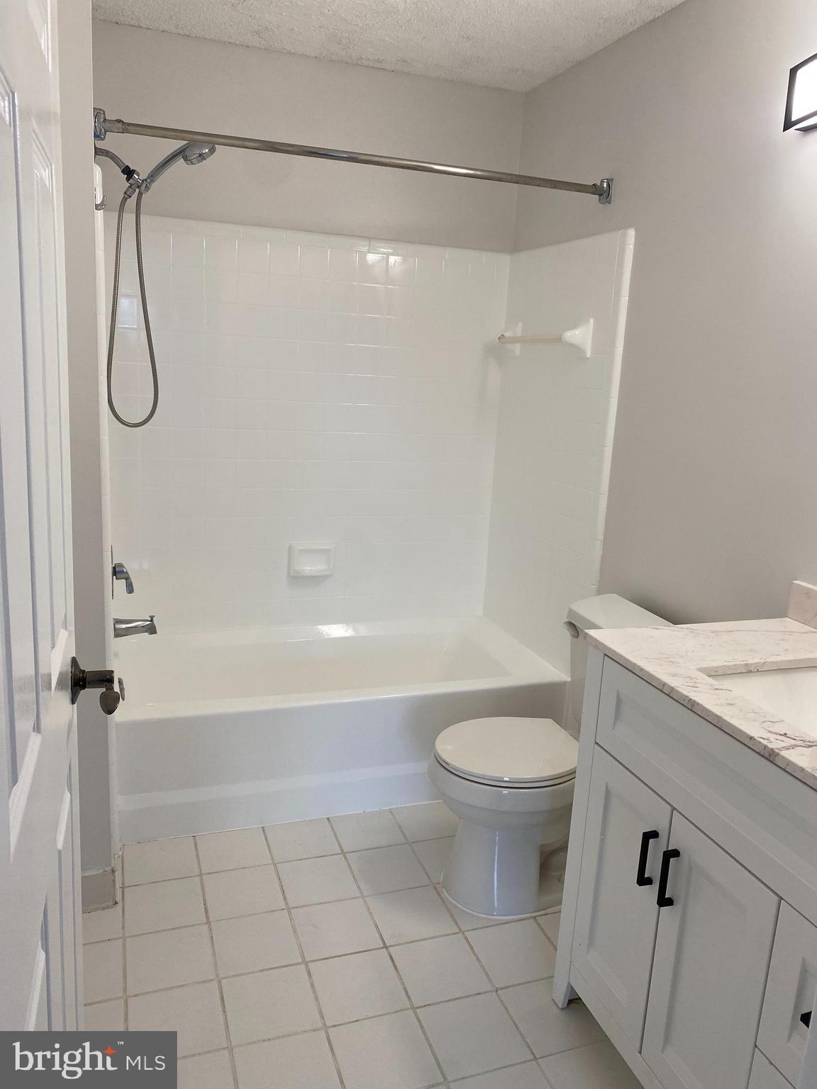 12106 Greenway Court, Unit 302 Fairfax, VA 22033 - Photo 13 of 20 a bathroom with a granite countertop sink a toilet and shower