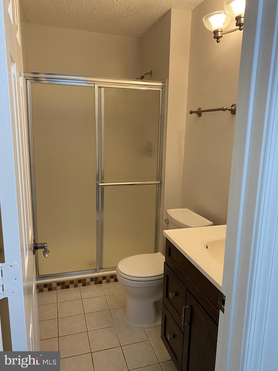 12106 Greenway Court, Unit 302 Fairfax, VA 22033 - Photo 15 of 20 a bathroom with a granite countertop sink toilet and shower