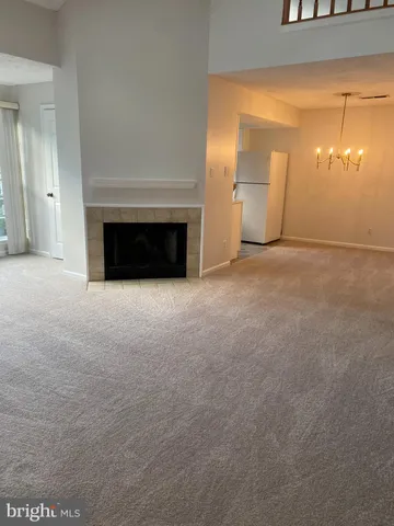 a view of an empty room with a fireplace