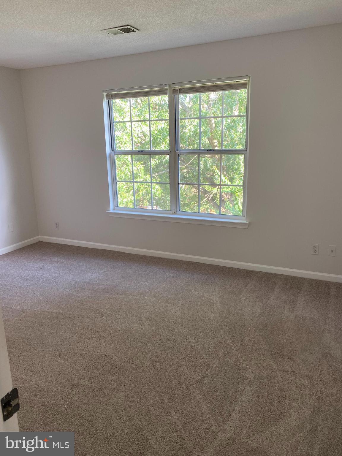 12106 Greenway Court, Unit 302 Fairfax, VA 22033 - Photo 8 of 20 an empty room with a window