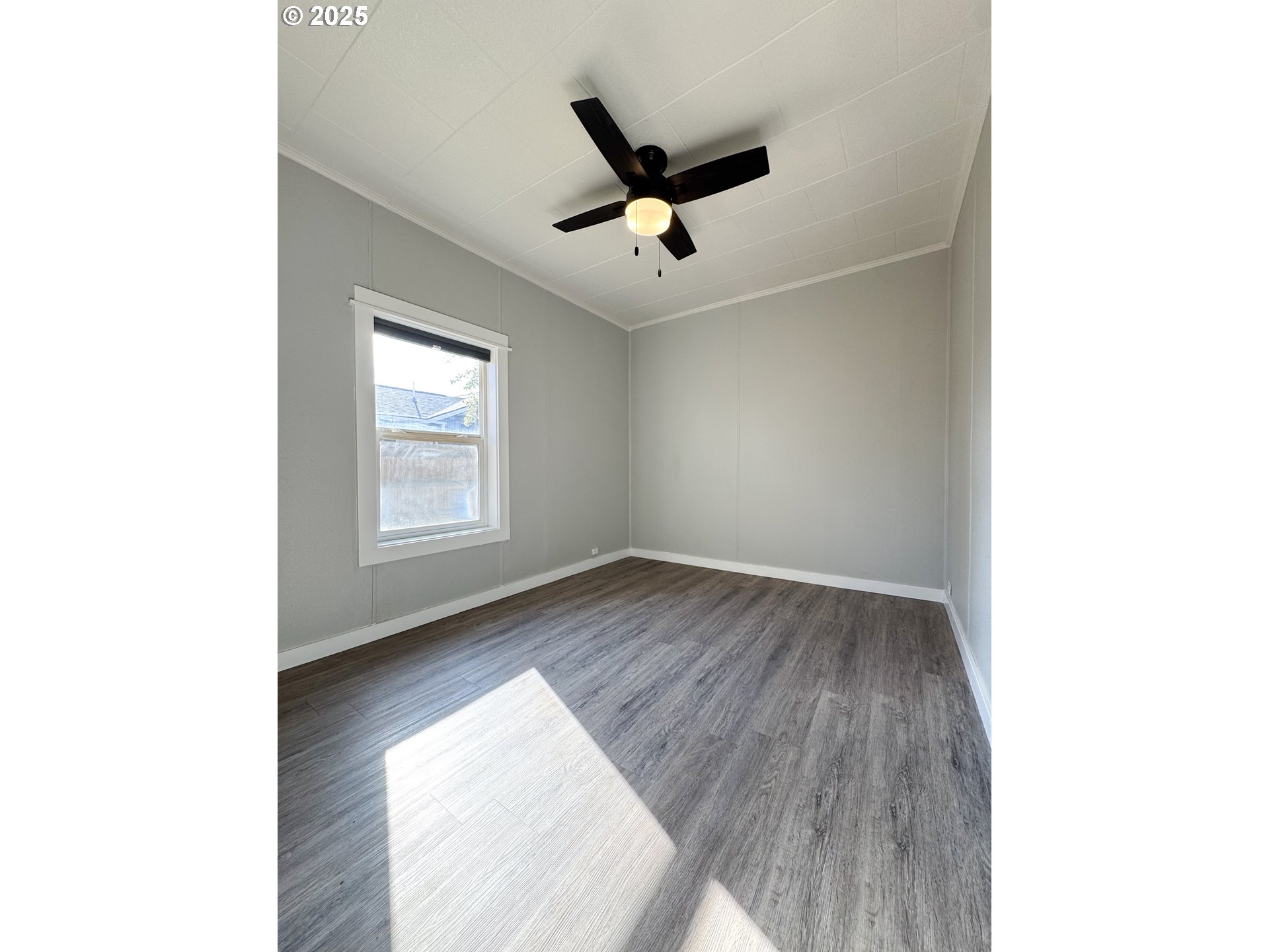 971 Walnut Street Baker City, OR 97814 - Photo 11 of 19 a view of a livingroom with a ceiling fan and window